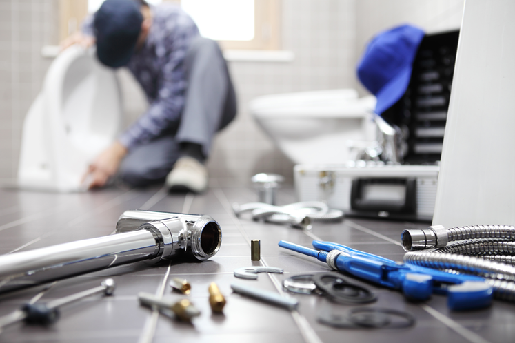 Plumber fixing sink